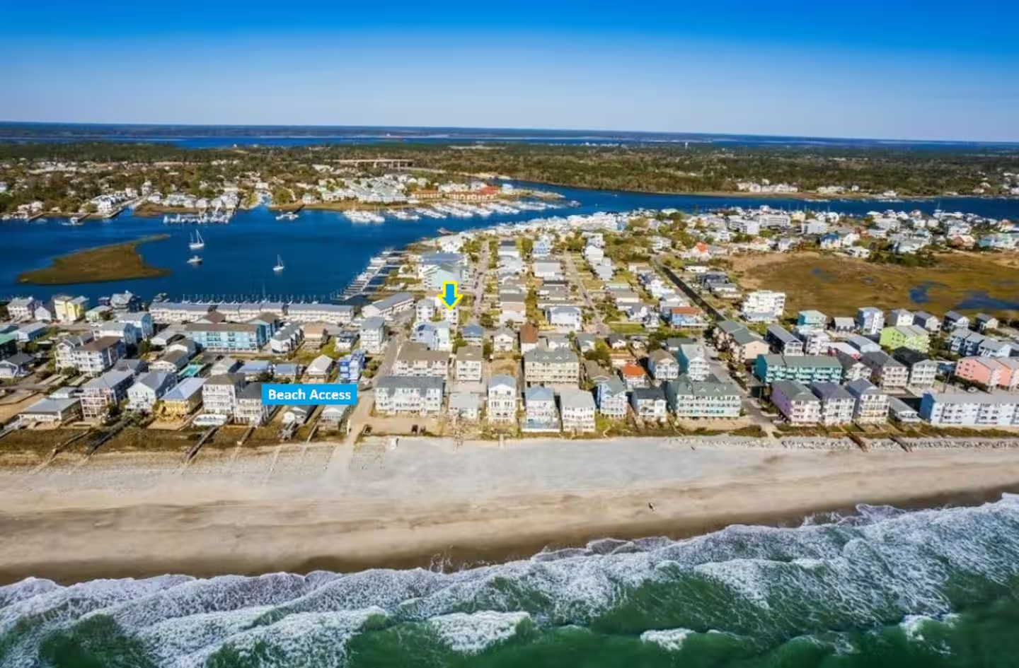 Aerial view showing Shore Thing Y’all between the canal and the nearby Carolina Beach access